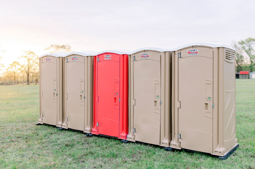 A row of five portable toilets
